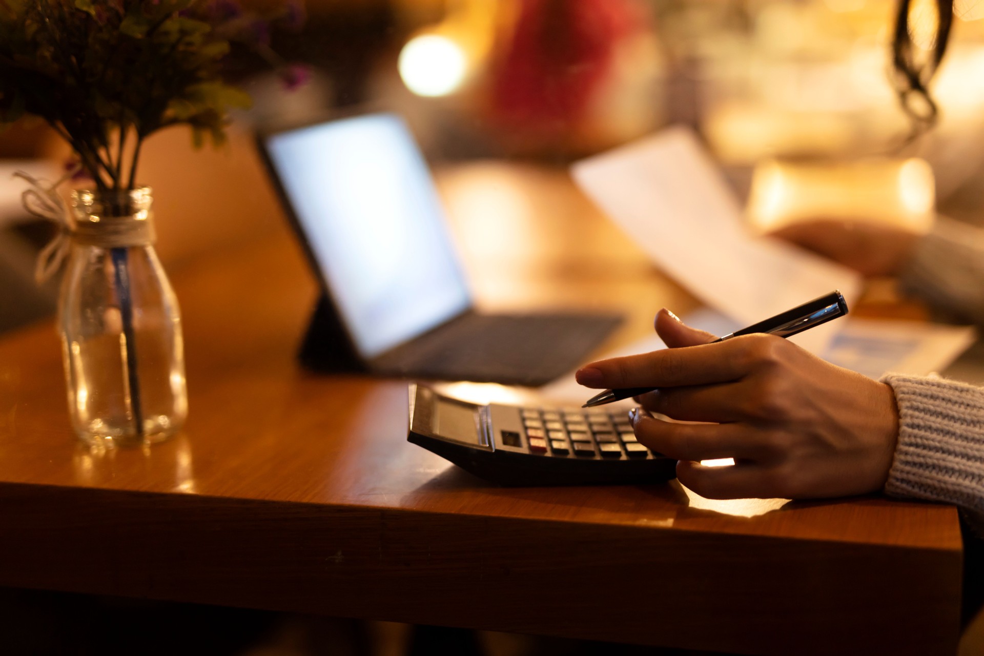 Business woman using calculator and laptop for do math finance